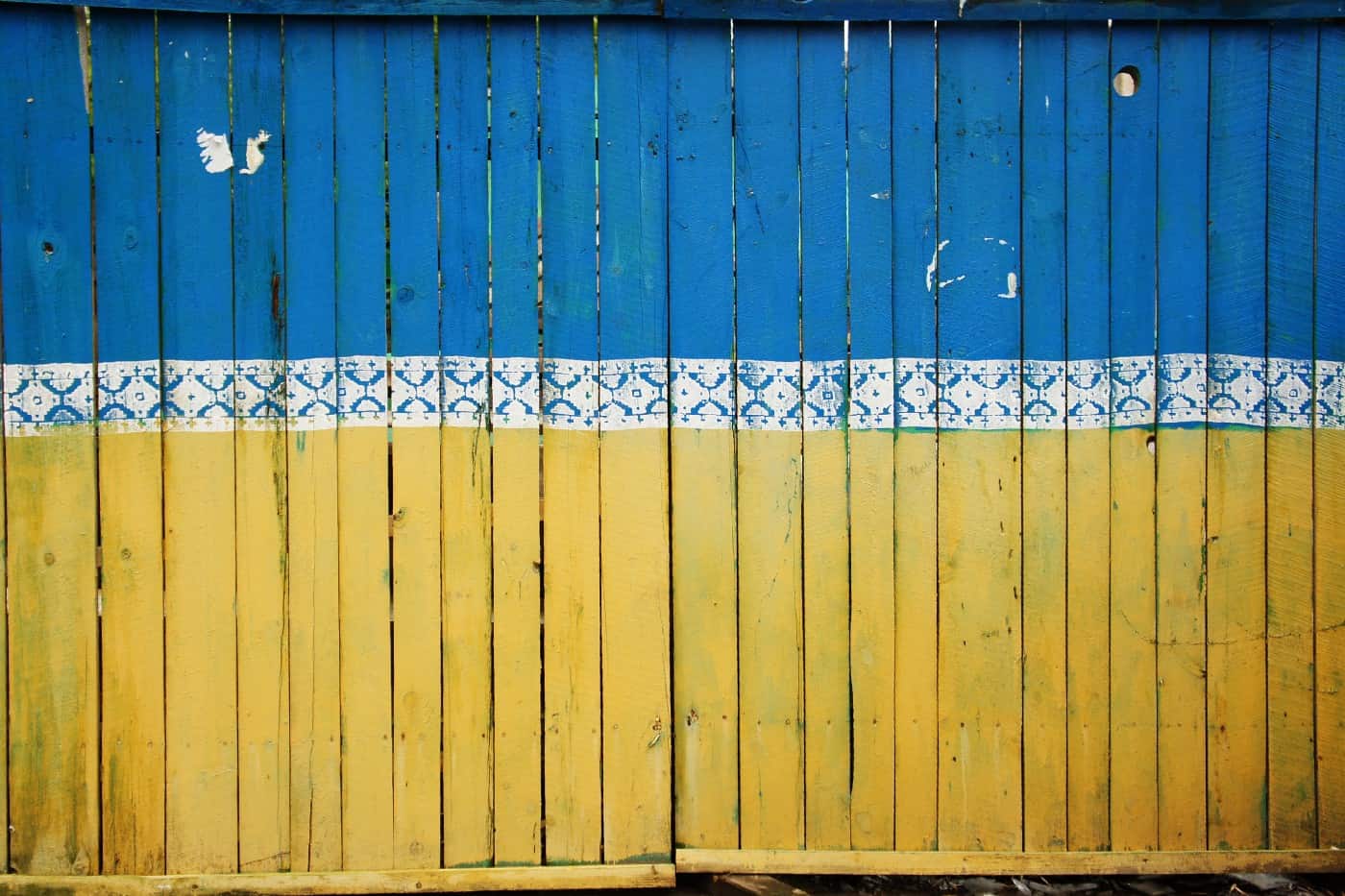 Ukraine flag painted on fence.